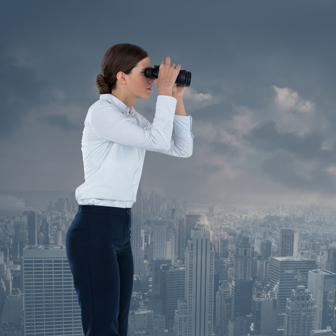 businesswoman with binoculars in cityscape
