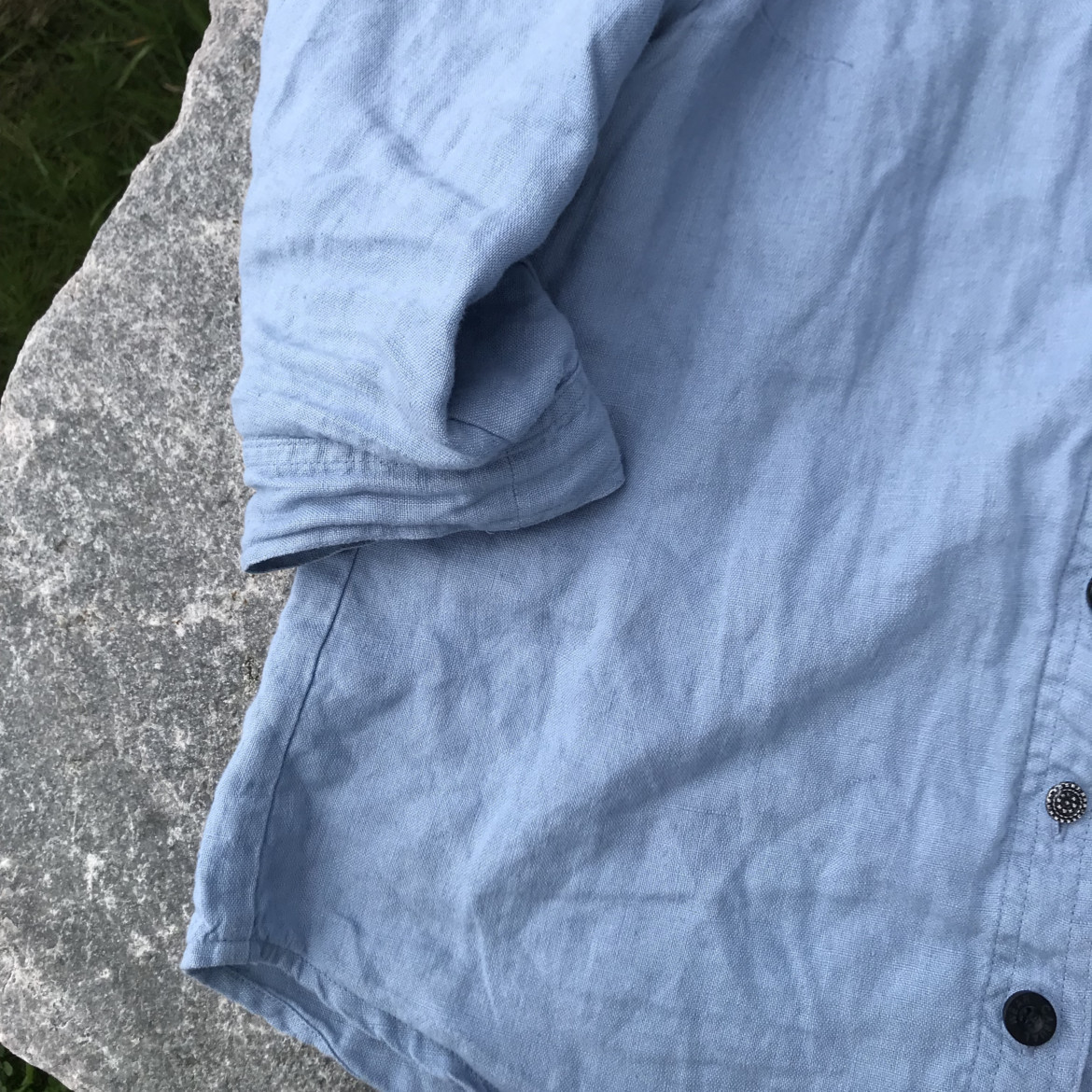 blue shirt on a rock